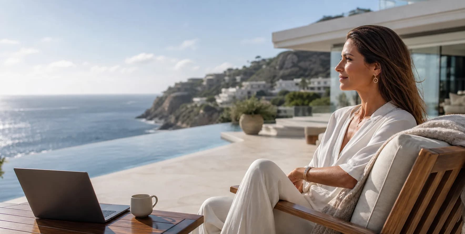 A woman enjoying a calm luxury workday beside an ocean-view infinity pool
